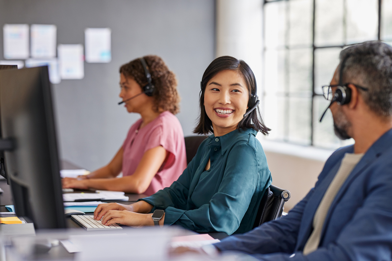 Smiling customer service team collaborate together